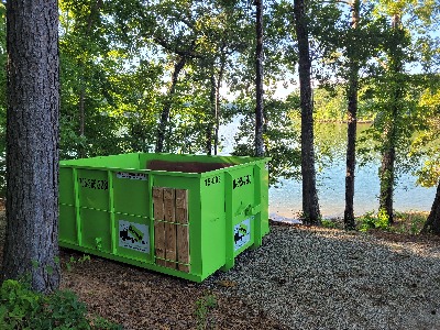 Auburn Dumpster Rental in a forest near a lake